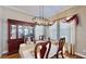 The dining area features a dark wood china cabinet and a modern chandelier over the table at 310 Manns Harbor Dr, Apollo Beach, FL 33572