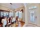 Traditional dining room boasts a wooden table set for four, a decorative rug and classic wood flooring at 310 Manns Harbor Dr, Apollo Beach, FL 33572