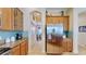 Charming kitchen with stainless steel refrigerator, wooden cabinets, and tile backsplash at 310 Manns Harbor Dr, Apollo Beach, FL 33572