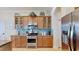 Bright kitchen with stainless steel appliances, granite counters, and glass-front cabinets at 310 Manns Harbor Dr, Apollo Beach, FL 33572