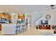 Open living space with bar seating at the kitchen island and views to the staircase at 310 Manns Harbor Dr, Apollo Beach, FL 33572