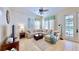 Inviting living room features a plush sectional sofa, stylish decor, tile flooring, and abundant natural light at 310 Manns Harbor Dr, Apollo Beach, FL 33572