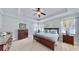 The main bedroom has a tray ceiling, neutral walls, and carpeted floors at 310 Manns Harbor Dr, Apollo Beach, FL 33572