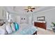 The main bedroom is decorated with light blue walls, crown molding, and a ceiling fan at 310 Manns Harbor Dr, Apollo Beach, FL 33572