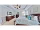 Main bedroom features a spacious layout, tray ceiling, and large windows for natural light at 310 Manns Harbor Dr, Apollo Beach, FL 33572