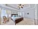 The main bedroom has a large bed and a sitting area by the window at 310 Manns Harbor Dr, Apollo Beach, FL 33572