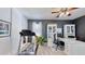 Well-lit home office with a treadmill, built-in storage, a large desk, and a modern ceiling fan at 310 Manns Harbor Dr, Apollo Beach, FL 33572