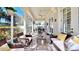 Covered porch featuring elegant columns, tile flooring, and comfortable seating at 310 Manns Harbor Dr, Apollo Beach, FL 33572