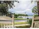 Scenic water view from the porch, showcasing a peaceful lake or canal with a clear view from comfortable rocking chairs at 310 Manns Harbor Dr, Apollo Beach, FL 33572
