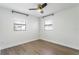 An empty bedroom with wood floors and two windows for ample natural light at 3303 W Price Ave, Tampa, FL 33611