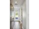 Hallway with access to the backyard through glass paneled doors at 3303 W Price Ave, Tampa, FL 33611