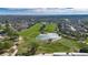 Aerial view showcasing a golf course, a serene pond, manicured green spaces and surrounding landscape at 3537 Valencia Cove Court, Land O Lakes, FL 34639