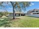 Spacious backyard with lush grass and mature trees, enhancing the outdoor living space of the home at 3537 Valencia Cove Court, Land O Lakes, FL 34639
