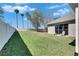 Expansive backyard with lush green grass, mature trees, and a white fence, creating a private outdoor oasis at 3537 Valencia Cove Court, Land O Lakes, FL 34639