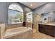Well lit bathroom with a soaking tub, vanity, and walk-in shower at 3537 Valencia Cove Court, Land O Lakes, FL 34639