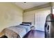 Well-lit bedroom with gray bedframe, hardwood floors, closet, and a cozy ambiance at 3537 Valencia Cove Court, Land O Lakes, FL 34639