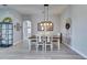 Light-filled dining room featuring wood-look tile flooring, neutral walls, and stylish pendant lighting at 3537 Valencia Cove Court, Land O Lakes, FL 34639
