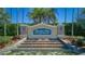 Elegant community entrance featuring a stone waterfall and lush landscaping, creating a grand welcome at 3537 Valencia Cove Court, Land O Lakes, FL 34639