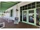 Charming clubhouse exterior with rocking chairs, brick patio, and inviting entrance, perfect for relaxing after a round of golf at 3537 Valencia Cove Court, Land O Lakes, FL 34639