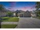 Beautiful home with an inviting exterior, showcasing a well-kept lawn, a long driveway, and a cozy ambiance at 3537 Valencia Cove Court, Land O Lakes, FL 34639