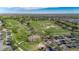 This aerial view captures a golf course with well-maintained greens, sand traps, and a parking area at 3537 Valencia Cove Court, Land O Lakes, FL 34639