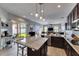 Open-concept kitchen with granite countertops, stainless steel appliances and views to the outside patio and living room at 3537 Valencia Cove Court, Land O Lakes, FL 34639