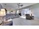 Spacious living room featuring wood-look tile flooring, neutral walls, and large windows for ample natural light at 3537 Valencia Cove Court, Land O Lakes, FL 34639