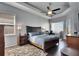 Serene bedroom features a tray ceiling, a ceiling fan, dark wood floors, and a tranquil ambiance at 3537 Valencia Cove Court, Land O Lakes, FL 34639