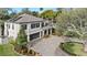 Stunning home features a solar-paneled roof, lush landscaping, and a beautiful brick-paved driveway at 3605 E Tampa Cir, Tampa, FL 33629