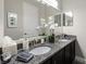 Bathroom with double vanity and granite countertop providing a functional and elegant space at 3605 E Tampa Cir, Tampa, FL 33629