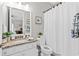 Bright bathroom features a granite vanity, framed mirror, and a shower with white curtain at 3605 E Tampa Cir, Tampa, FL 33629