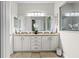 Elegant bathroom with double sinks, a large mirror, and refined decor at 3605 E Tampa Cir, Tampa, FL 33629