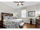 Cozy bedroom with hardwood floors, a comfortable bed, and a large window for natural light at 3605 E Tampa Cir, Tampa, FL 33629