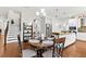 Dining area with hardwood floors, modern lighting, and easy access to the kitchen and living areas at 3605 E Tampa Cir, Tampa, FL 33629