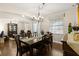 Elegant dining room with a dark wood table, stylish chandelier, and hardwood floors at 3605 E Tampa Cir, Tampa, FL 33629