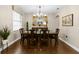 Formal dining room showcasing hardwood floors, modern lighting fixture, and elegant decor at 3605 E Tampa Cir, Tampa, FL 33629
