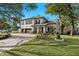 Charming two-story home with stone accents, lush landscaping, and a brick-paved driveway at 3605 E Tampa Cir, Tampa, FL 33629