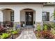 Inviting front porch featuring a decorative door, arched entryways and attractive stone accents at 3605 E Tampa Cir, Tampa, FL 33629