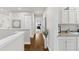 Upstairs hallway with hardwood floors, neutral paint, and access to bedrooms at 3605 E Tampa Cir, Tampa, FL 33629
