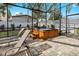 The screen enclosed brick patio features a wooden hot tub and lounge chairs at 3605 E Tampa Cir, Tampa, FL 33629