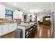 Bright kitchen with granite countertops, center island with seating, and stainless steel appliances at 3605 E Tampa Cir, Tampa, FL 33629