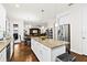 Open kitchen featuring a center island with seating, stainless steel appliances, and access to the living area at 3605 E Tampa Cir, Tampa, FL 33629