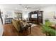 Open living room featuring hardwood floors, stylish furniture, and a large entertainment center at 3605 E Tampa Cir, Tampa, FL 33629