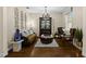 Cozy formal living room with a comfortable sofa, hardwood floors, and a decorative display case at 3605 E Tampa Cir, Tampa, FL 33629