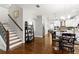 Open concept living area featuring stairs, dining area, and a kitchen with stainless steel appliances at 3605 E Tampa Cir, Tampa, FL 33629