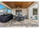 Covered patio with wooden ceiling, ceiling fans and a large outdoor table with seating for eight at 3605 E Tampa Cir, Tampa, FL 33629