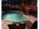A luxurious pool area is illuminated with tiki torches and includes an inviting brick patio with comfortable lounge chairs at 3605 E Tampa Cir, Tampa, FL 33629