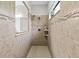 Tiled stand-up shower with tiled accent stripes and built in shelving at 3605 E Tampa Cir, Tampa, FL 33629