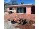Backyard featuring an outdoor patio, sliding glass doors, rock landscaping, and a small garden at 3800 Belle Vista E Dr, St Pete Beach, FL 33706