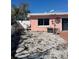 Enclosed backyard with rock landscaping, patio, and privacy fence, ideal for outdoor living and entertaining at 3800 Belle Vista E Dr, St Pete Beach, FL 33706